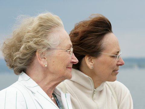 zwei Frauen älter und jünger in der Profilansicht mit Blick auf Meer